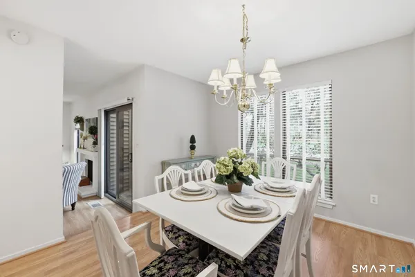 a view of a dining room with furniture window and wooden floor