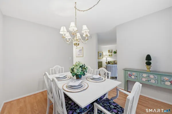 a view of a dining room with furniture and chandelier