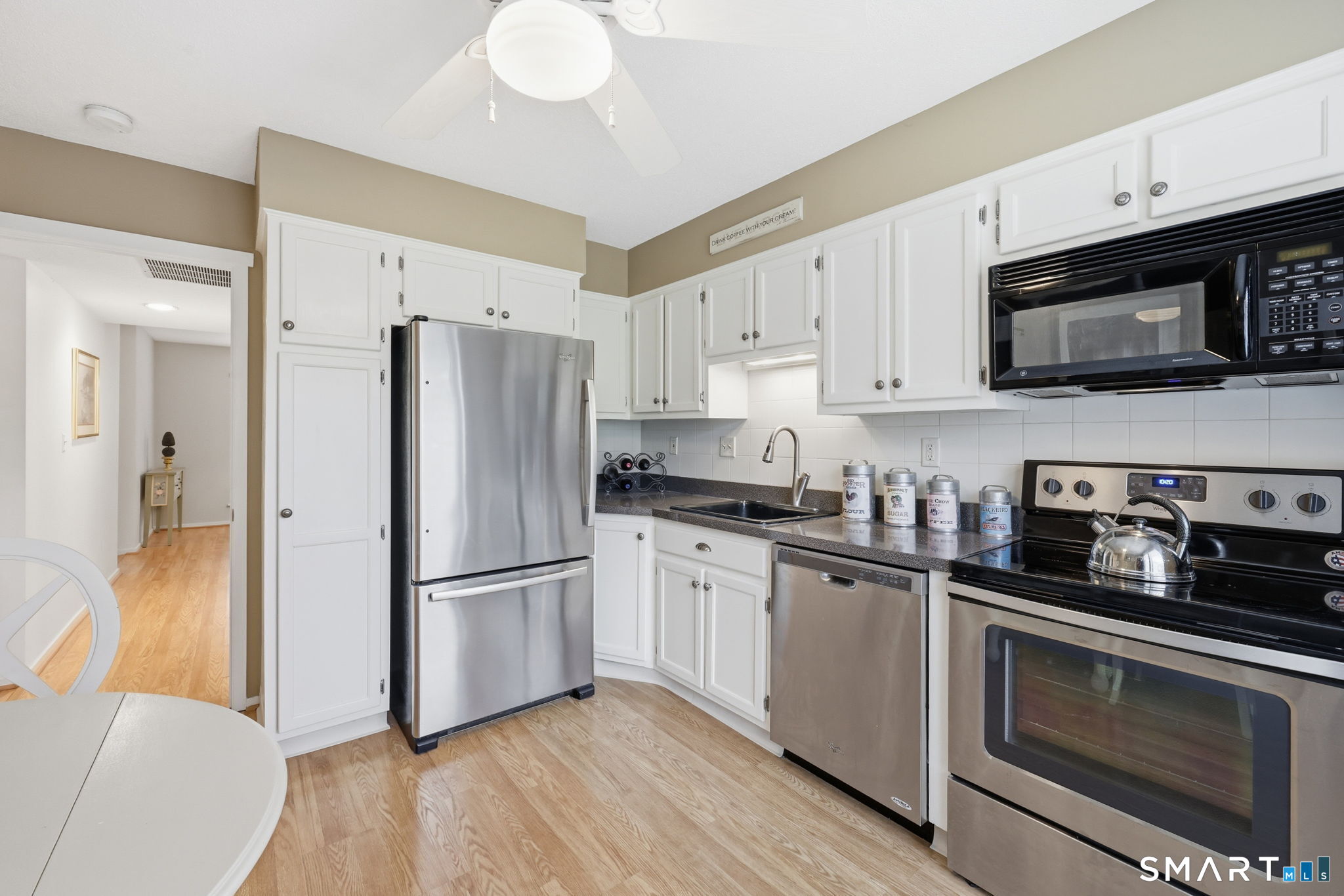 23 Maple Lane, Unit 23 Avon, CT 06001 - Photo 8 of 33 a kitchen with stainless steel appliances a refrigerator stove and microwave