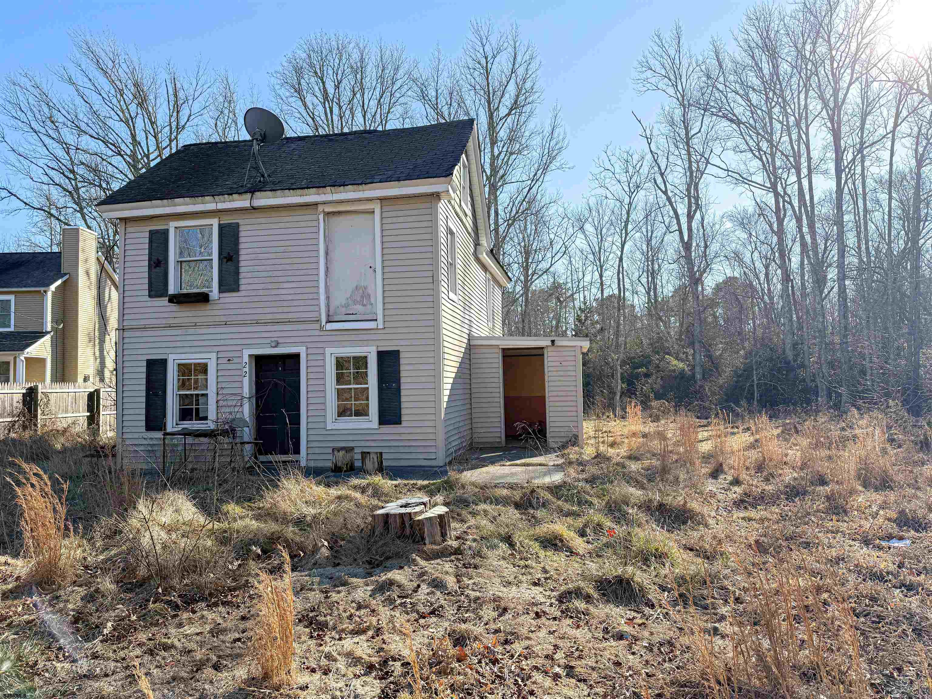 a front view of house with yard and trees around