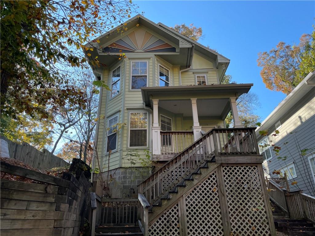 a view of a house with wooden fence