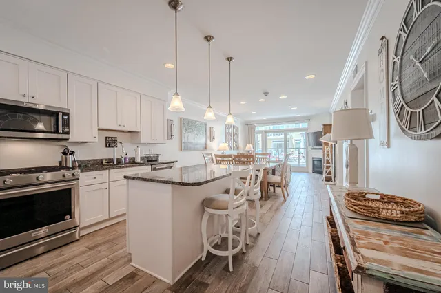 a large kitchen with kitchen island a stove a sink a center island and a stove