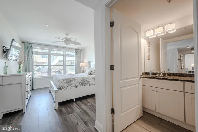 a spacious bedroom with a bed and wooden floor