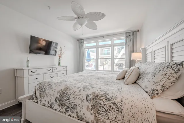 a bedroom with a large bed and a flat screen tv