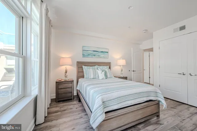 a bedroom with a bed and a large window