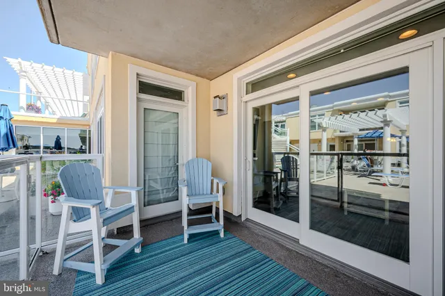 a view of a room with chairs and front door