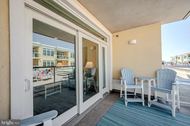 a view of a chairs and a table in the balcony