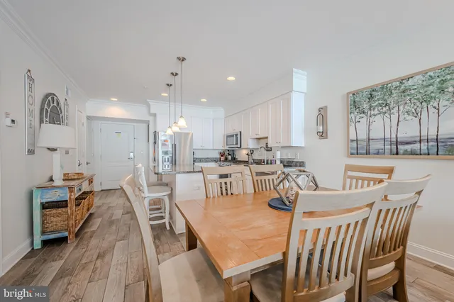 a view of a dining room with furniture and a large window