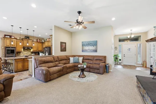 a living room with furniture a fireplace and a large window
