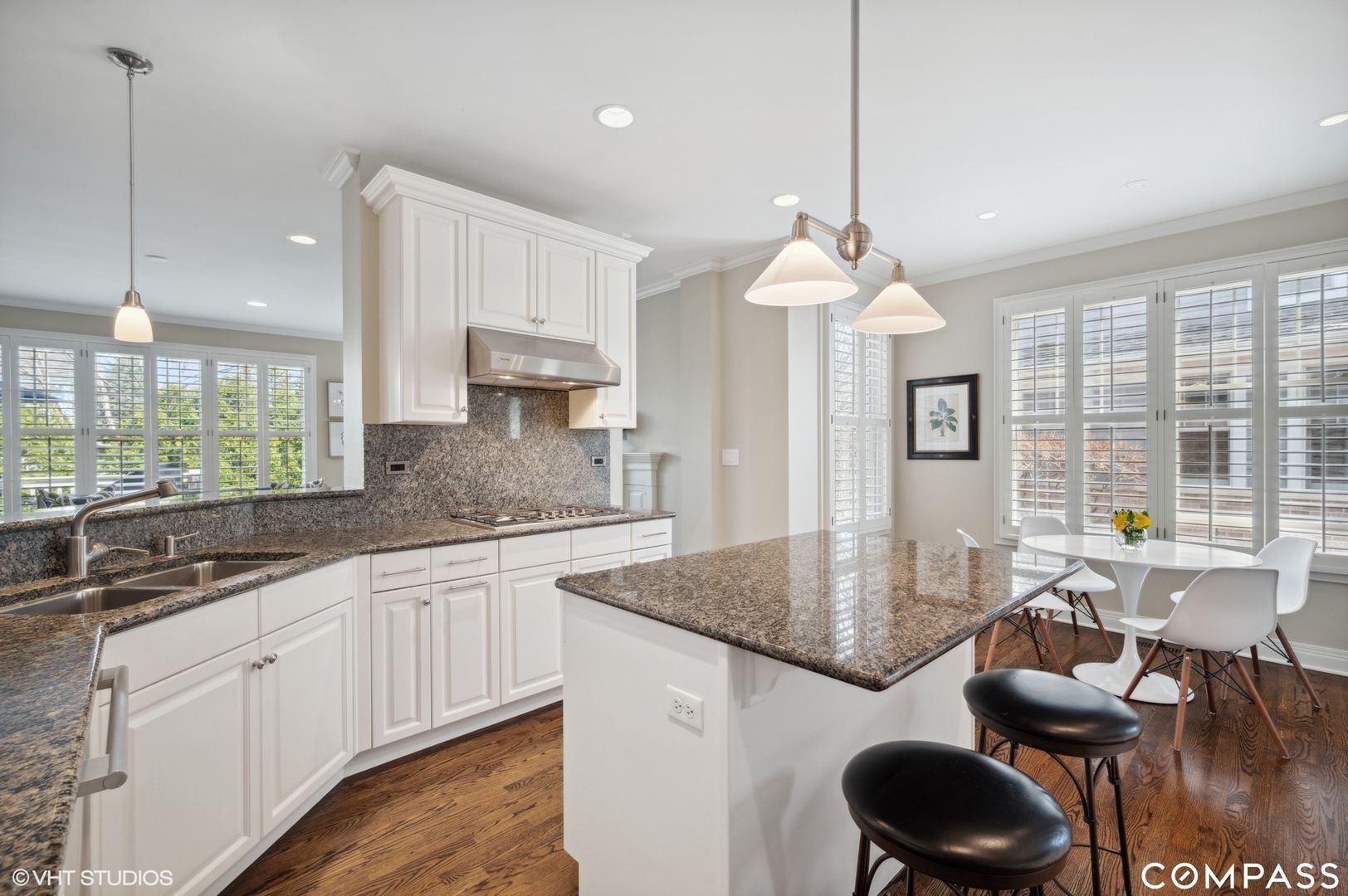 1437 Kittyhawk Lane Glenview, IL 60026 - Photo 13 of 39 a kitchen with granite countertop kitchen island white cabinets and a chandelier