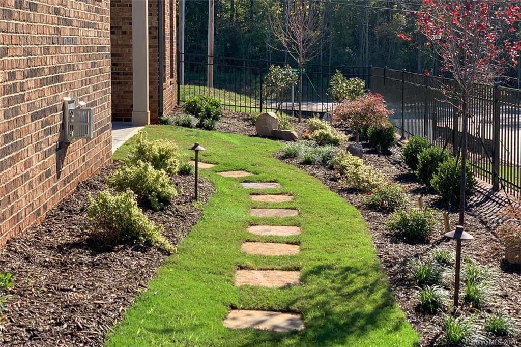 3002 Portico Place, Unit 38 Tega Cay, SC 29708 - Photo 12 of 38 a view of a garden with a fountain