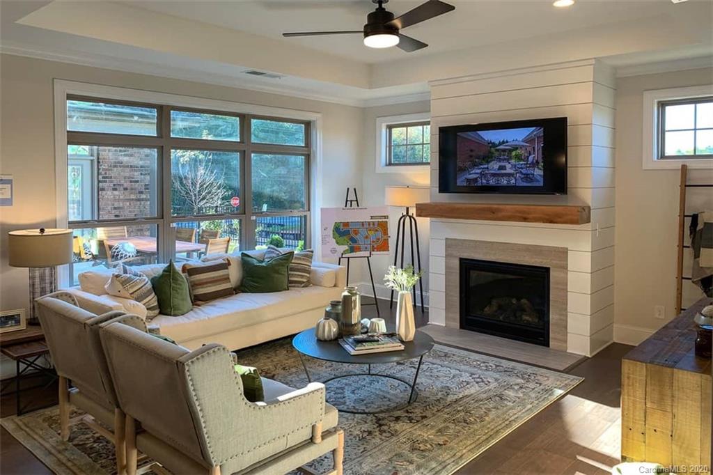 3002 Portico Place, Unit 38 Tega Cay, SC 29708 - Photo 21 of 38 a living room with furniture and a fireplace