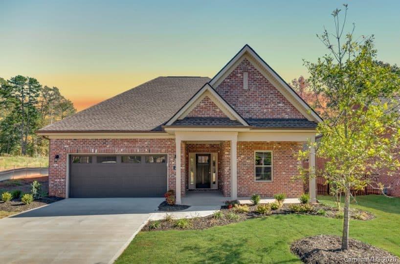 3002 Portico Place, Unit 38 Tega Cay, SC 29708 - Photo 4 of 38 a front view of a house with a yard and garage