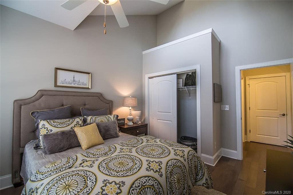 3002 Portico Place, Unit 38 Tega Cay, SC 29708 - Photo 31 of 38 a bedroom with a bed and a chandelier
