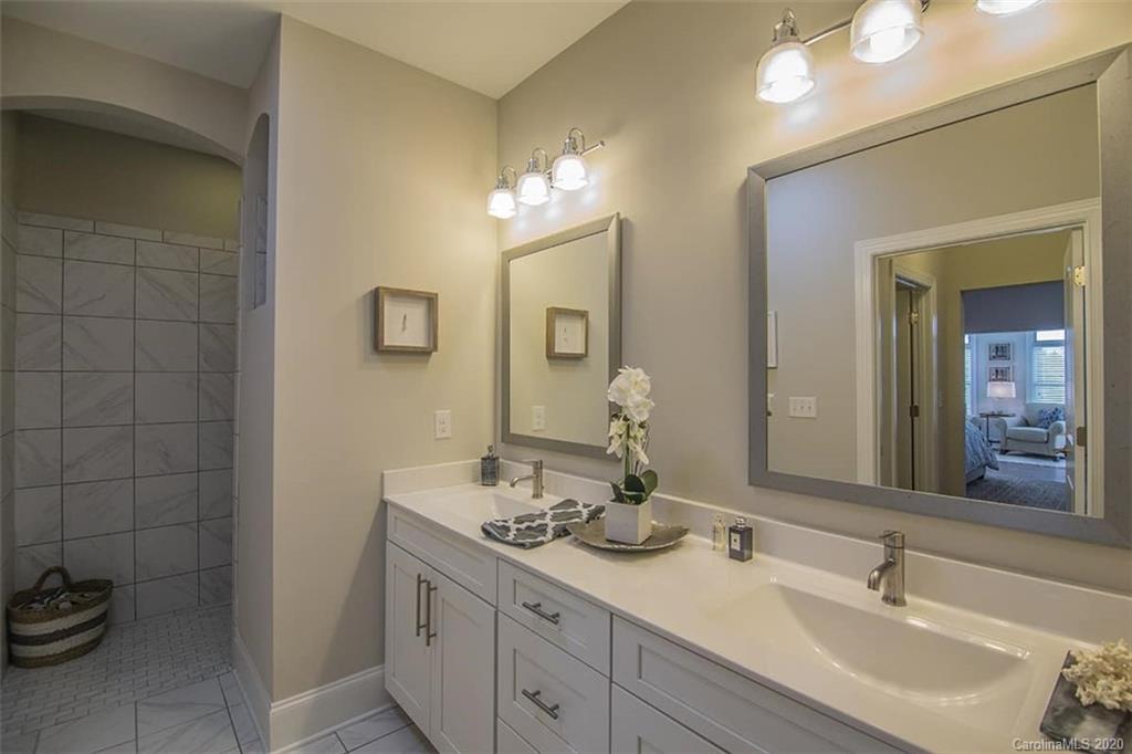 3002 Portico Place, Unit 38 Tega Cay, SC 29708 - Photo 32 of 38 a bathroom with a double vanity sink and a mirror