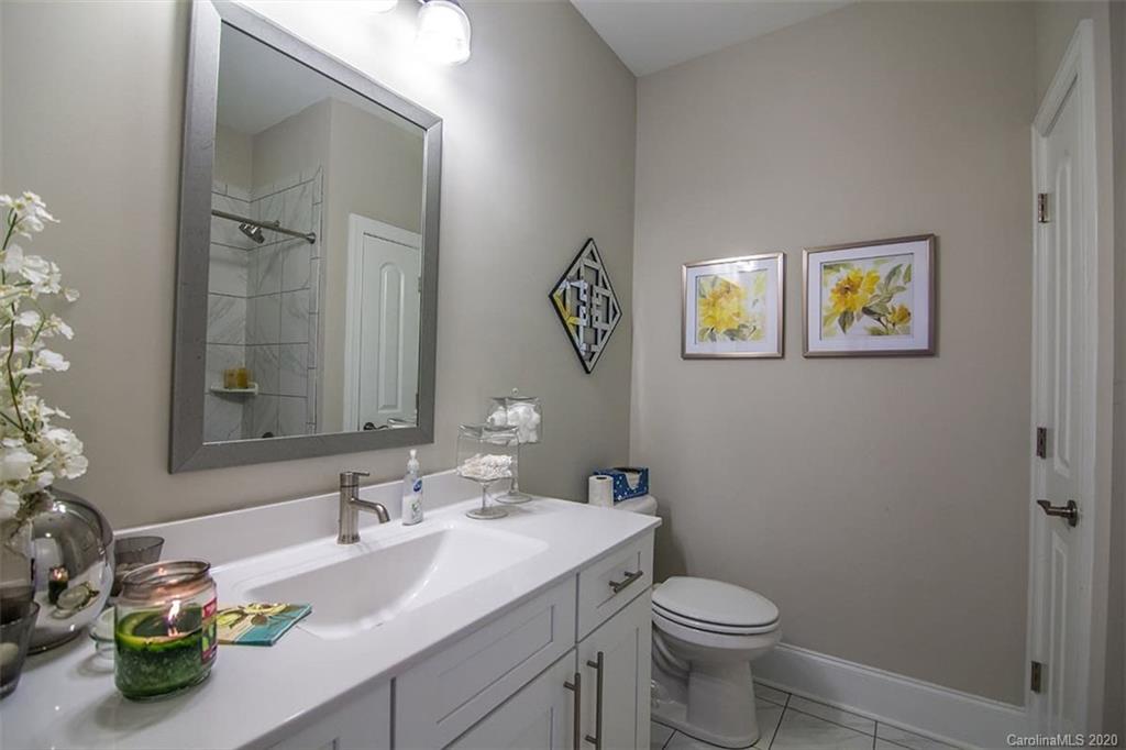 3002 Portico Place, Unit 38 Tega Cay, SC 29708 - Photo 33 of 38 a bathroom with a granite countertop sink mirror and toilet