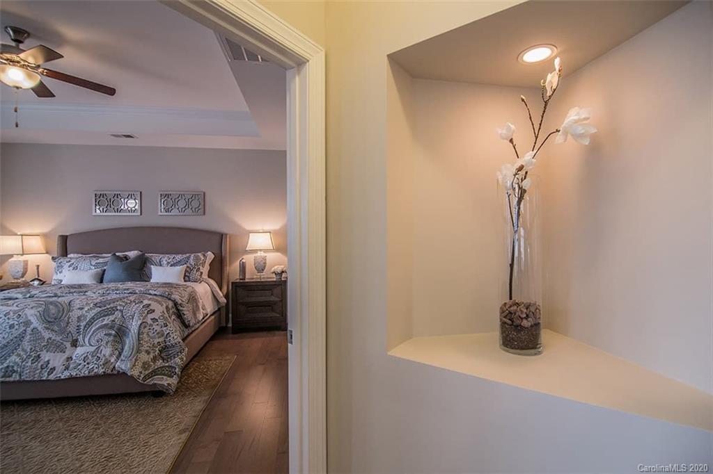 3002 Portico Place, Unit 38 Tega Cay, SC 29708 - Photo 34 of 38 a bedroom with a bed and a night stand