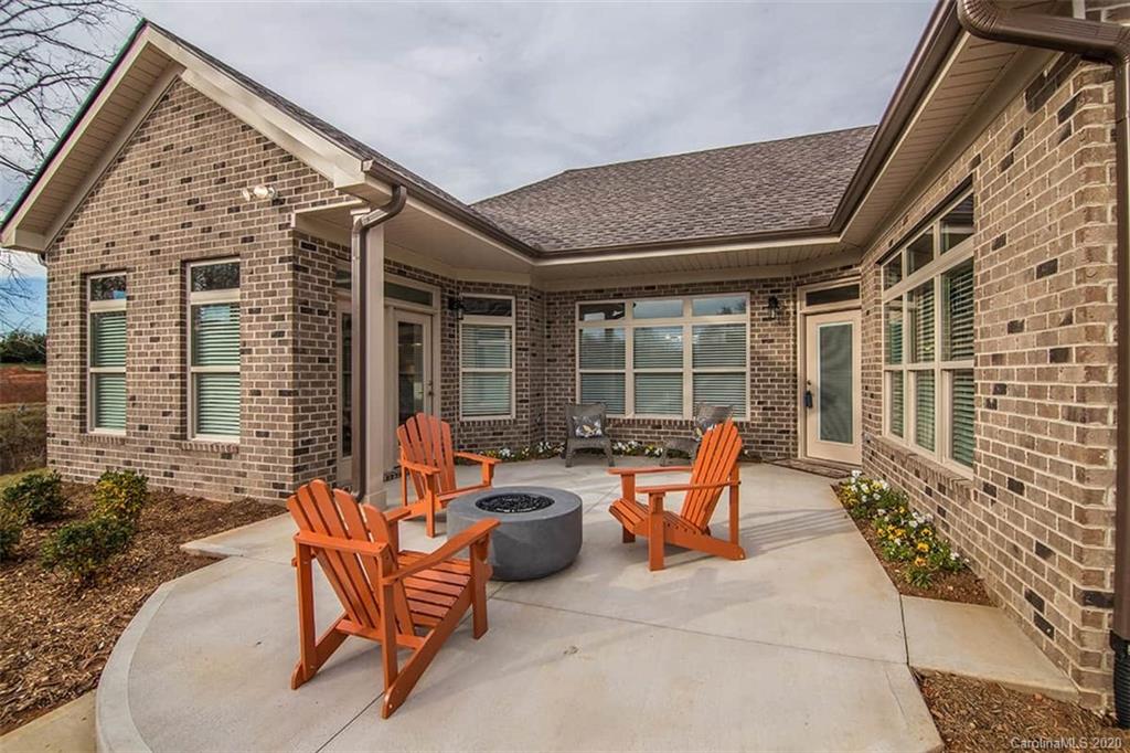 3002 Portico Place, Unit 38 Tega Cay, SC 29708 - Photo 10 of 38 a outdoor space with patio furniture and potted plants
