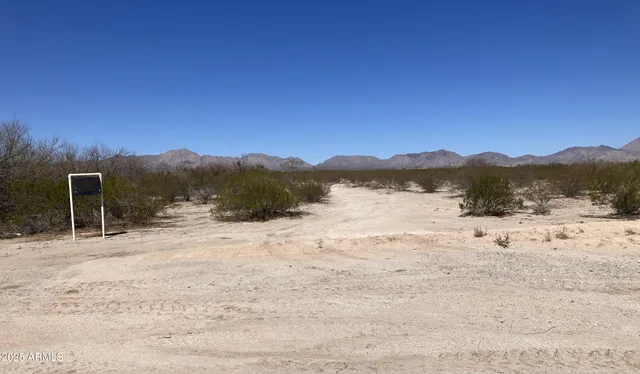 a view of a mountain with a yard