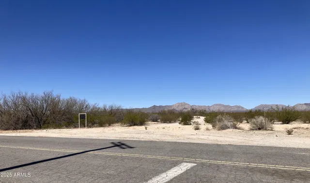a view of a road with mountains in the background