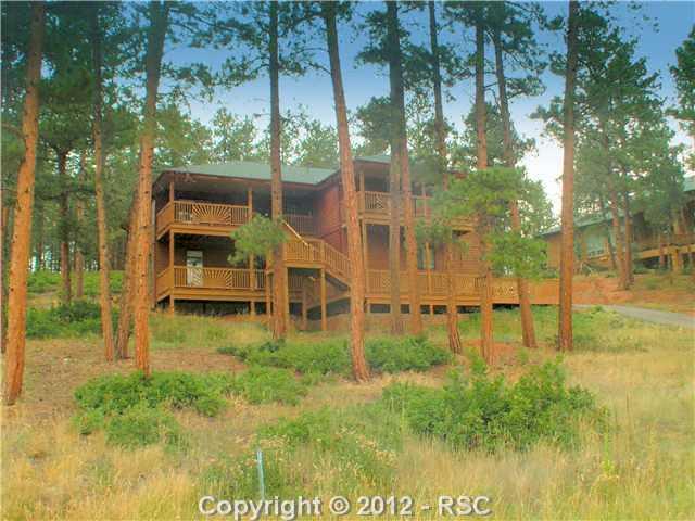 8211 Inca Road Larkspur, CO 80118 - Photo 1 of 24 Moderately treed lot, low maintenance landscaping.
