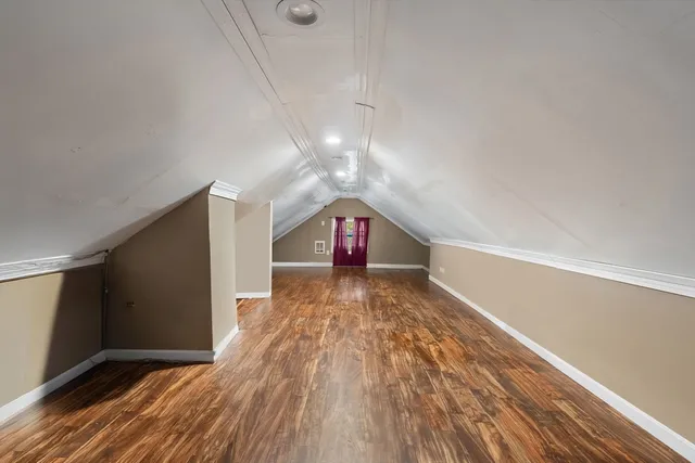 a view of a room with wooden floor and window