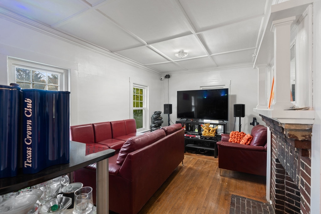 80 Ferry Street, Unit 80A Lawrence, MA 01841 - Photo 18 of 38 a living room with furniture a flat screen tv and a fireplace