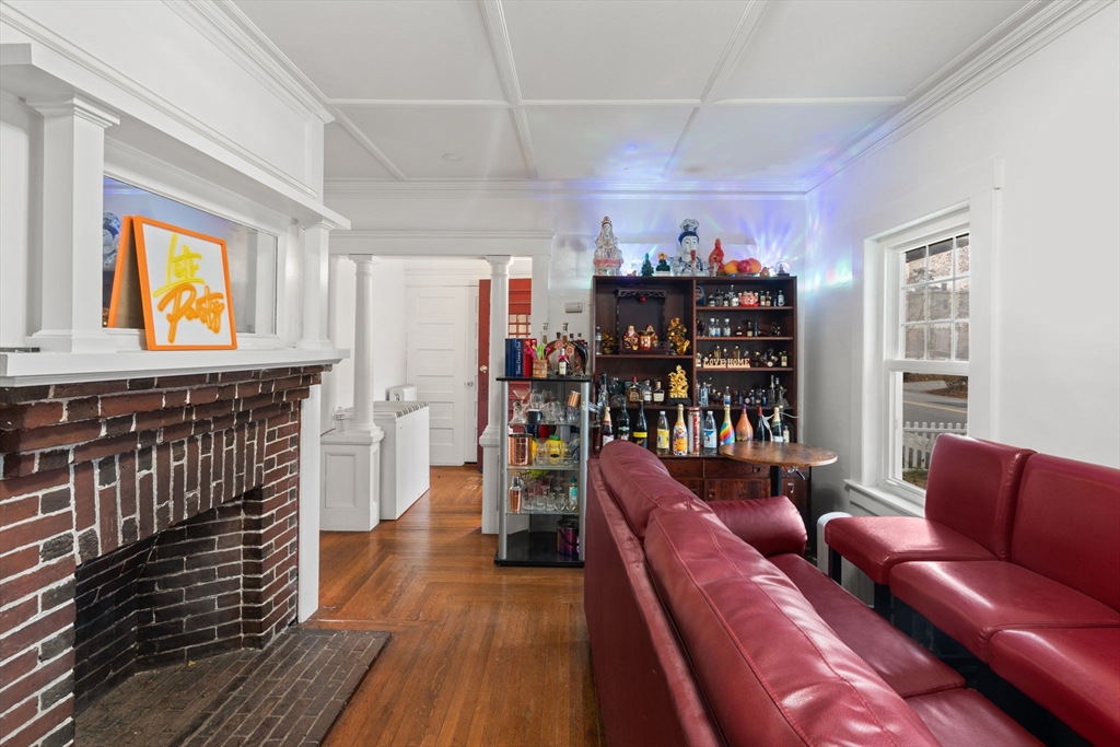 80 Ferry Street, Unit 80A Lawrence, MA 01841 - Photo 19 of 38 a living room with furniture a bookshelf and a book shelf