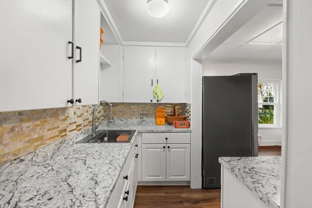 a kitchen with a sink stove and refrigerator