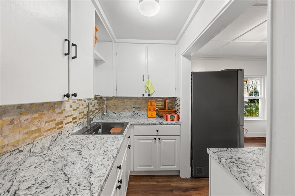 80 Ferry Street, Unit 80A Lawrence, MA 01841 - Photo 23 of 38 a kitchen with a sink stove and refrigerator