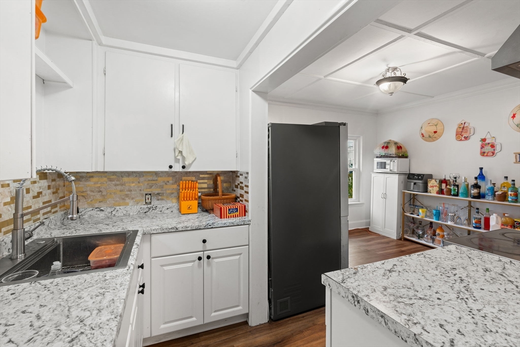 80 Ferry Street, Unit 80A Lawrence, MA 01841 - Photo 24 of 38 a kitchen with stainless steel appliances granite countertop a sink stove and refrigerator