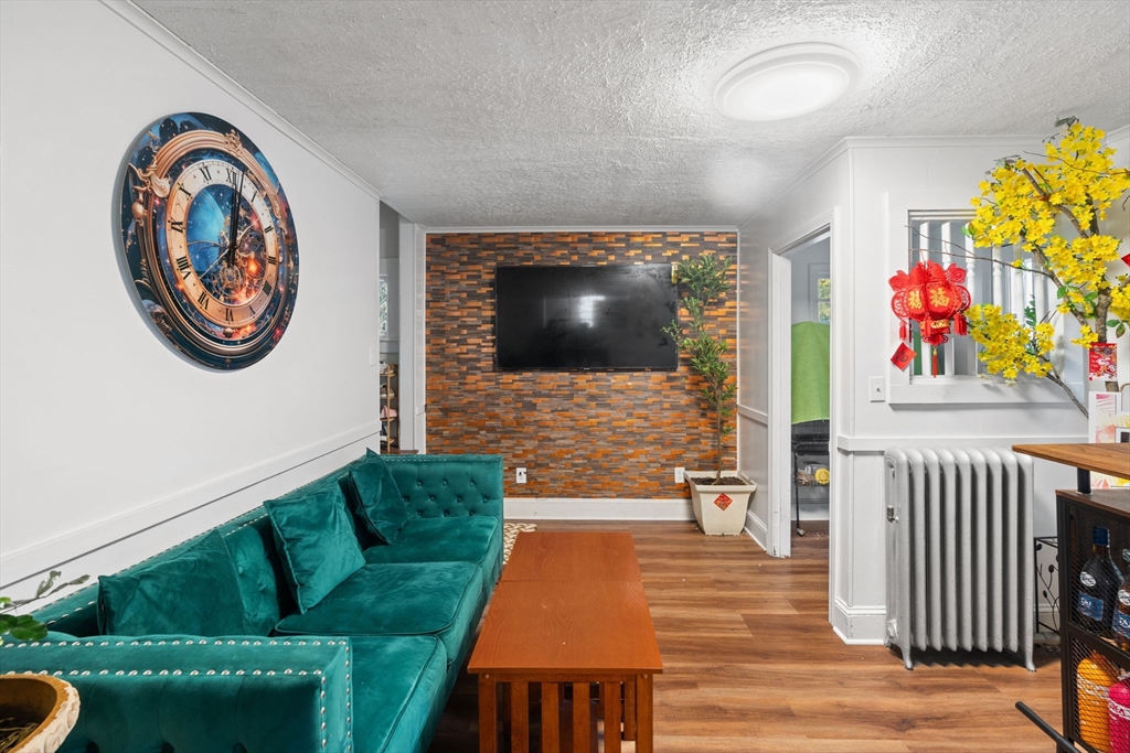 80 Ferry Street, Unit 80A Lawrence, MA 01841 - Photo 26 of 38 a living room with furniture and a flat screen tv