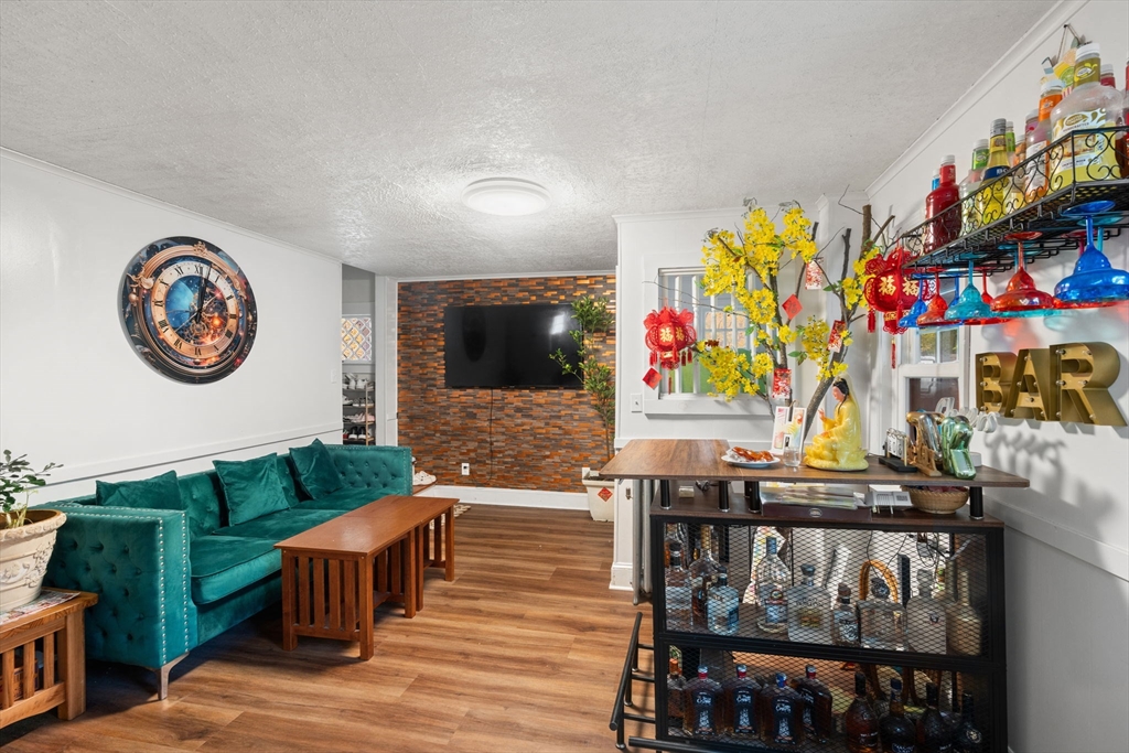 80 Ferry Street, Unit 80A Lawrence, MA 01841 - Photo 27 of 38 a living room with furniture and a flat screen tv