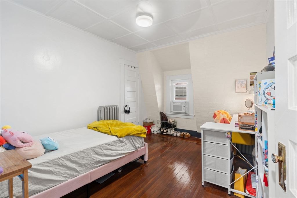 80 Ferry Street, Unit 80A Lawrence, MA 01841 - Photo 7 of 38 a bedroom with furniture and a wooden floor