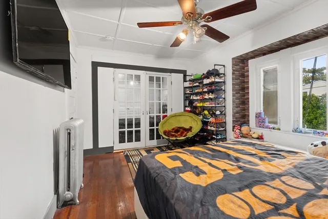 a bedroom with furniture and a flat screen tv