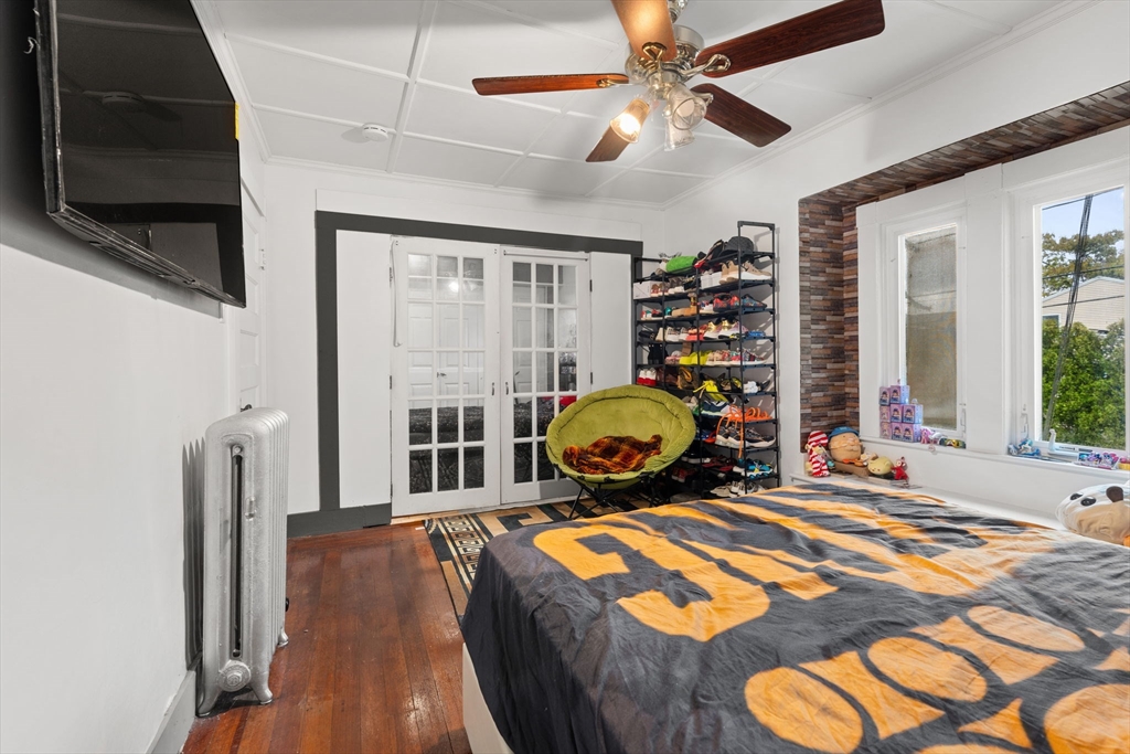 80 Ferry Street, Unit 80A Lawrence, MA 01841 - Photo 10 of 38 a bedroom with furniture and a flat screen tv