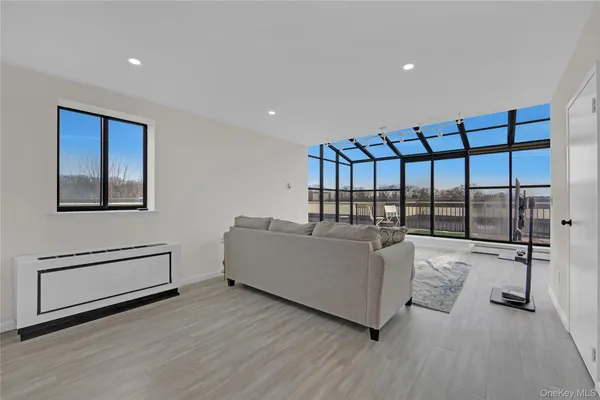 a living room with furniture a ceiling fan and a wooden floor