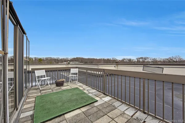 a view of a balcony with furniture