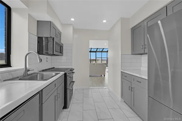 a kitchen with a sink stove and refrigerator