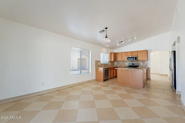 a kitchen with stainless steel appliances granite countertop a stove top oven a sink a counter top space and cabinets