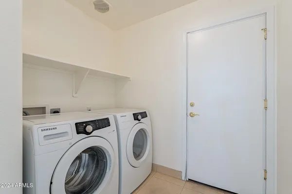 a view of storage and utility room with washer and dryer