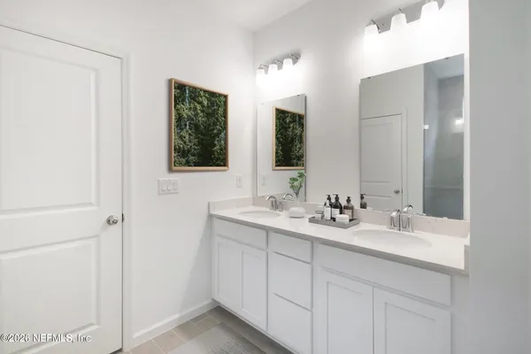 a bathroom with 2 sink and a mirror