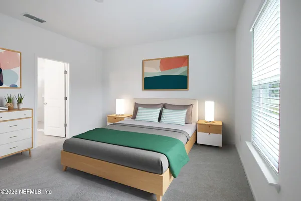 a bedroom with a bed and window