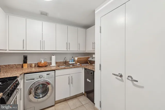 a utility room with sink dryer and washer