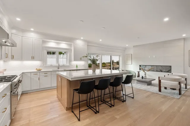 a kitchen with a sink and chairs