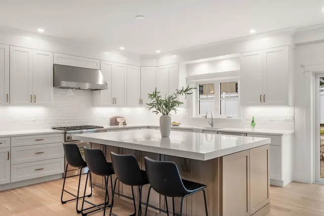 a kitchen with stainless steel appliances granite countertop a sink and a refrigerator