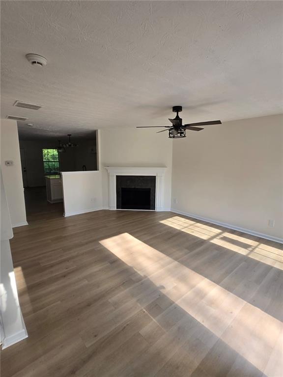 2868 Vining Ridge Terrace Decatur, GA 30034 - Photo 13 of 16 a view of a livingroom with a fireplace a ceiling fan and wooden floor