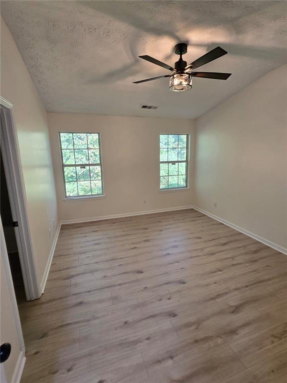 2868 Vining Ridge Terrace Decatur, GA 30034 - Photo 3 of 16 an empty room with wooden floor fan and windows