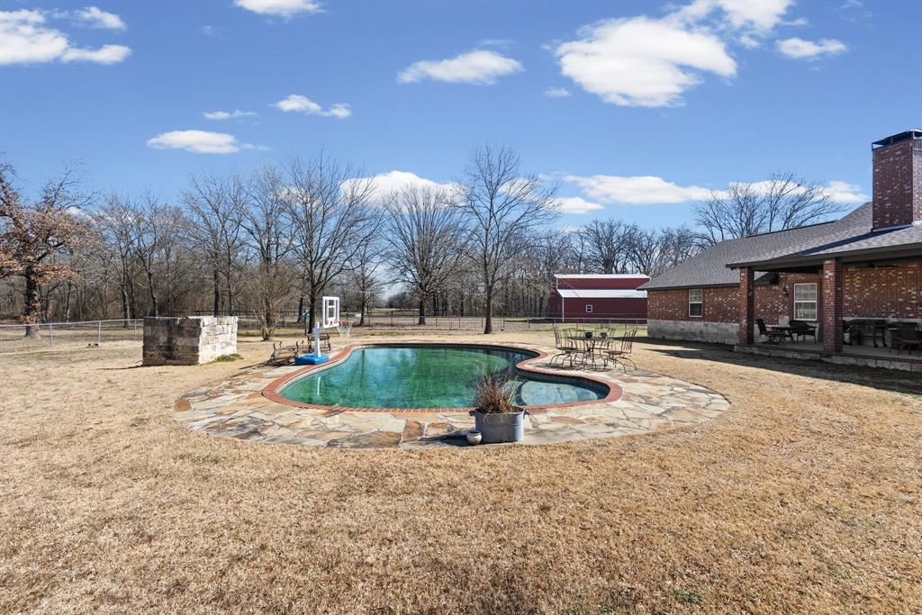 24 County Rd NW 1060 Talco, TX 75487 - Photo 31 of 40 a view of a swimming pool with a patio