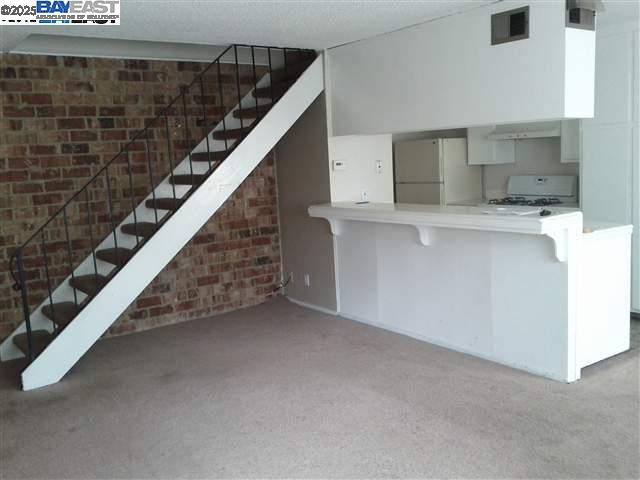 Pleasanton Pleasanton, CA 94588 - Photo 3 of 17 a view of kitchen with stairs and wooden floor